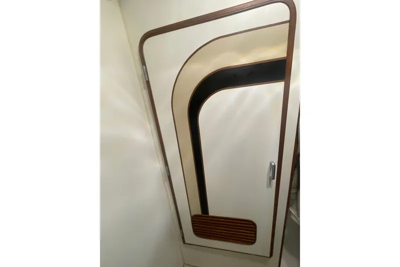 Slide: The Image of 1986 Hi-Star 40 Flybridge interior door with unique wood and black trim design. - 22