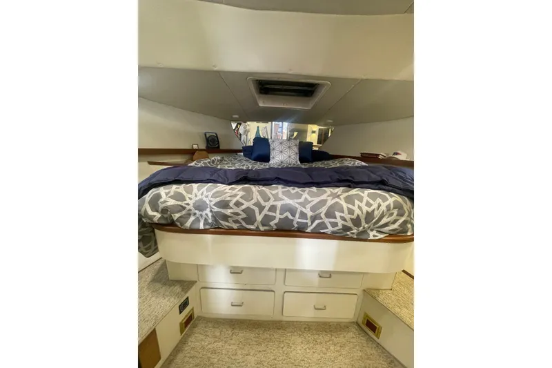 Slide: The Image of Cozy bedroom interior of 1986 Hi-Star 40 Flybridge yacht with patterned bedding. - 23