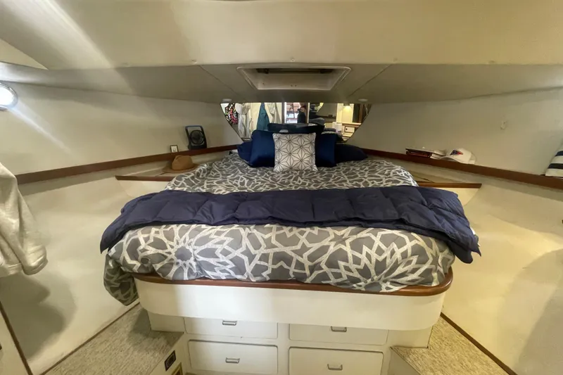 Slide: The Image of Cozy bedroom interior of 1986 Hi-Star 40 Flybridge yacht with patterned bedding. - 24