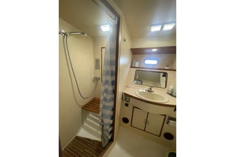 Slide: The Image of 1986 Hi-Star 40 Flybridge yacht bathroom with shower, sink, and mirror. - 25