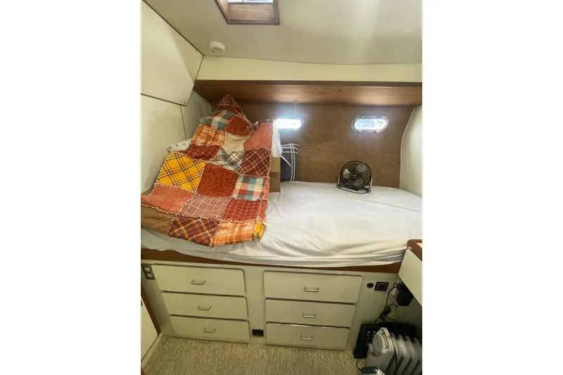 Slide: The Image of Cozy cabin interior of 1986 Hi-Star 40 Flybridge with patchwork quilt and storage drawers. - 29