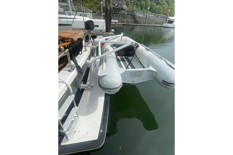 Slide: The Image of 1986 Hi-Star 40 Flybridge with inflatable dinghy docked at marina. - 3