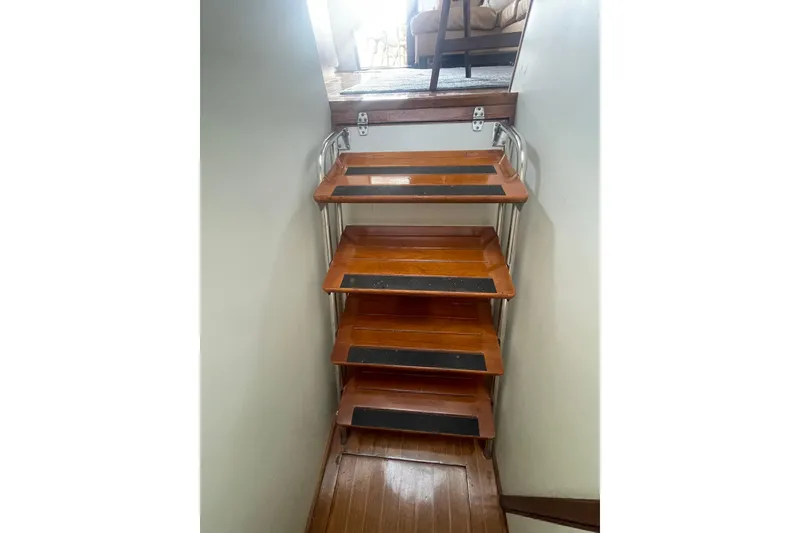 Slide: The Image of Wooden stairs inside a 1986 Hi-Star 40 Flybridge yacht, leading to the upper deck. - 30