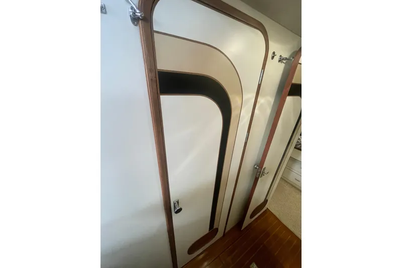Slide: The Image of 1986 Hi-Star 40 Flybridge interior door with wood trim and geometric design. - 32