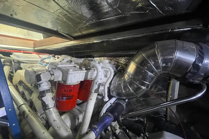 Slide: The Image of Engine room of 1986 Hi-Star 40 Flybridge with visible filters and exhaust system. - 42