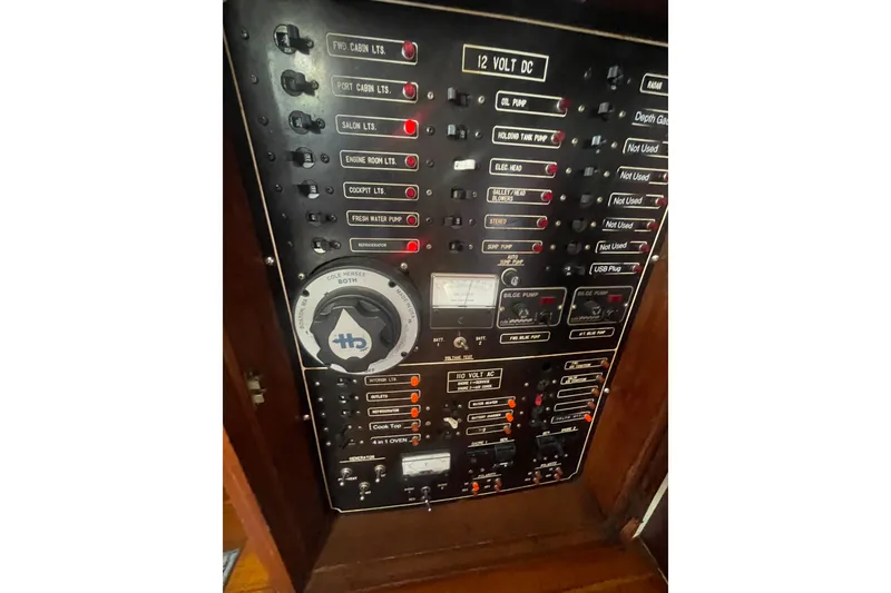 Slide: The Image of Control panel of a 1986 Hi-Star 40 Flybridge boat, featuring various switches and gauges. - 44
