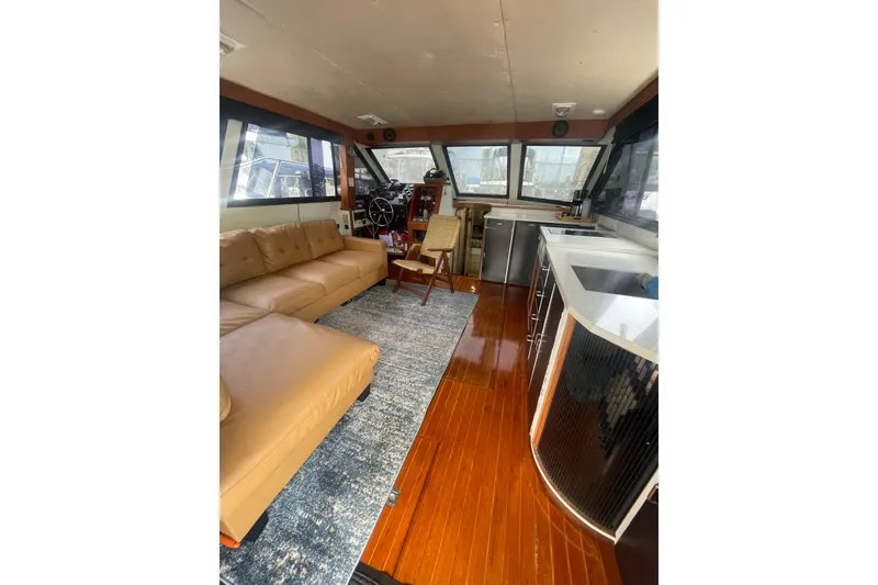 Slide: The Image of Interior of 1986 Hi-Star 40 Flybridge yacht with modern furnishings and wooden flooring. - 8