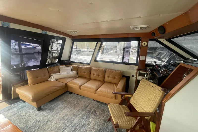 Slide: The Image of Interior of 1986 Hi-Star 40 Flybridge yacht with leather sofa and wicker chair. - 9