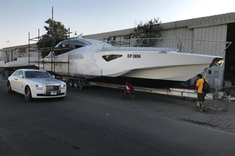 Slide: The Image of 2017 Tritons Express cruiser crossover beside luxury car in industrial setting. - 11