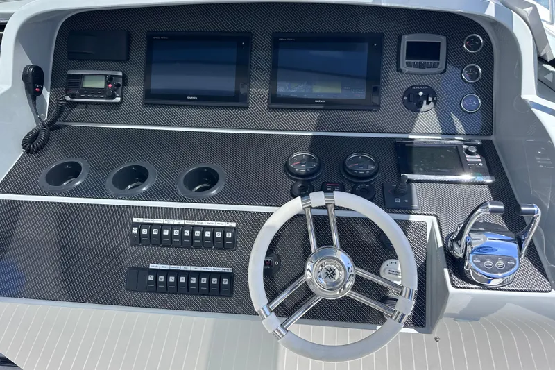 Slide: The Image of 2017 Tritons Express Cruiser Crossover on calm water, showcasing sleek design and modern features. - 8