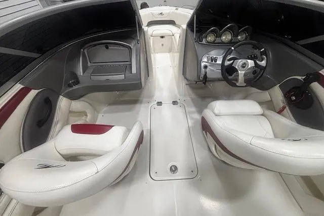 Slide: The Image of Interior of a 2008 Monterey 194FS boat with white seating and modern dashboard. - 12