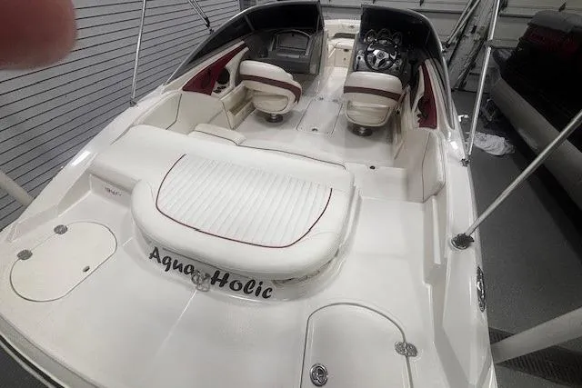 Slide: The Image of 2008 Monterey 194FS boat interior with white seating and "Aqua-Holic" text. - 13