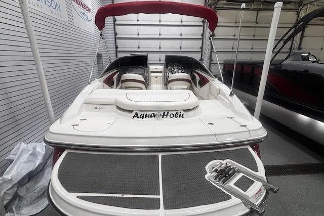 Slide: The Image of 2008 Monterey 194FS boat with red canopy, named "Aqua Holic," in a garage setting. - 15
