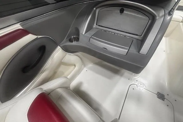 Slide: The Image of Interior of a 2008 Monterey 194FS boat, featuring red and white seating and storage compartment. - 16
