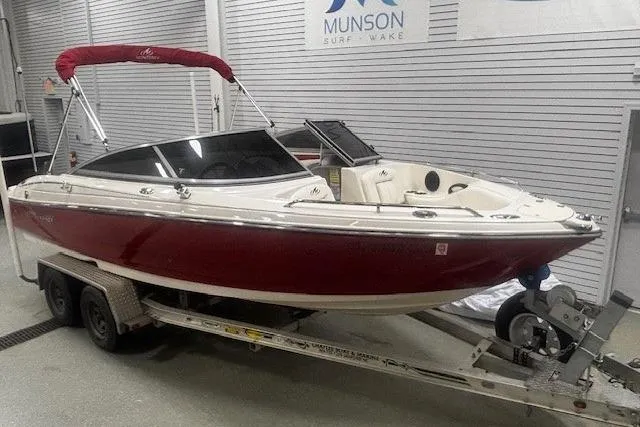 Slide: The Image of 2008 Monterey 194FS boat with red hull on trailer in indoor showroom. - 23