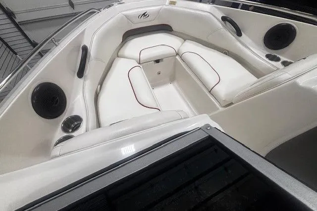 Slide: The Image of Interior of a 2008 Monterey 194FS boat with white seating and speakers. - 24