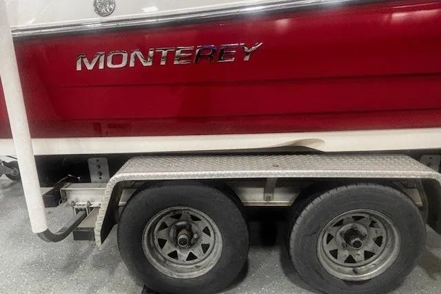 Slide: The Image of Red and white 2008 Monterey 194FS boat on a trailer with dual wheels. - 25