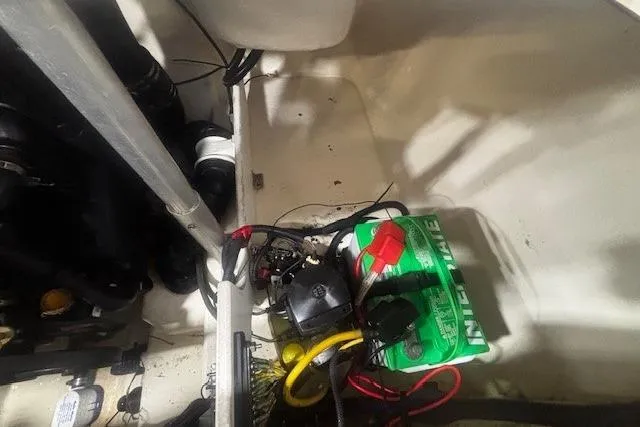 Slide: The Image of Engine compartment of a 2008 Monterey 194FS boat with battery and wiring visible. - 28