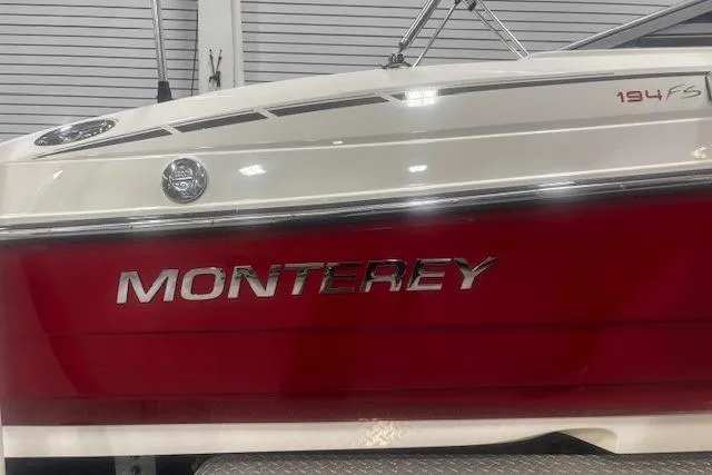 Slide: The Image of 2008 Monterey 194FS boat with red and white exterior, displayed indoors. - 7