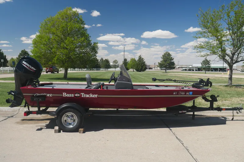 The Image of 2022 Tracker Bass Tracker Classic XL boat on trailer, parked outdoors under clear sky. - 0