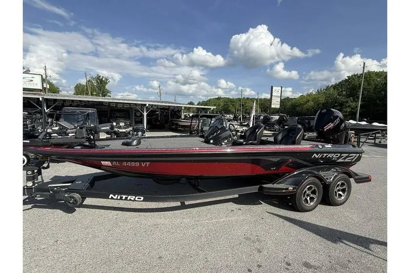 The Image of 2023 Nitro Z21 XL Pro boat on trailer under a clear blue sky. - 0