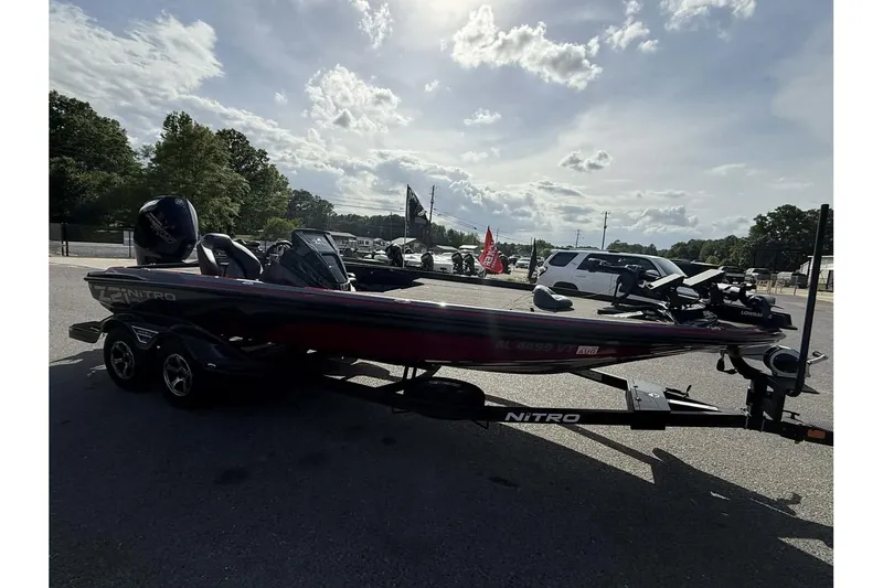 Slide: The Image of 2023 Nitro Z21 XL Pro boat on trailer in parking lot under cloudy sky. - 8