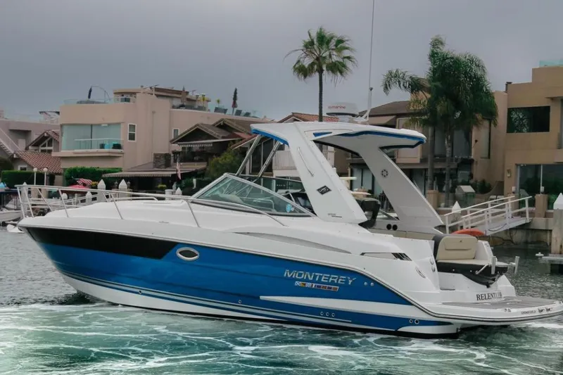 The Image of 2020 Monterey 355 Sport Yacht in marina, sleek design, blue and white exterior. - 0