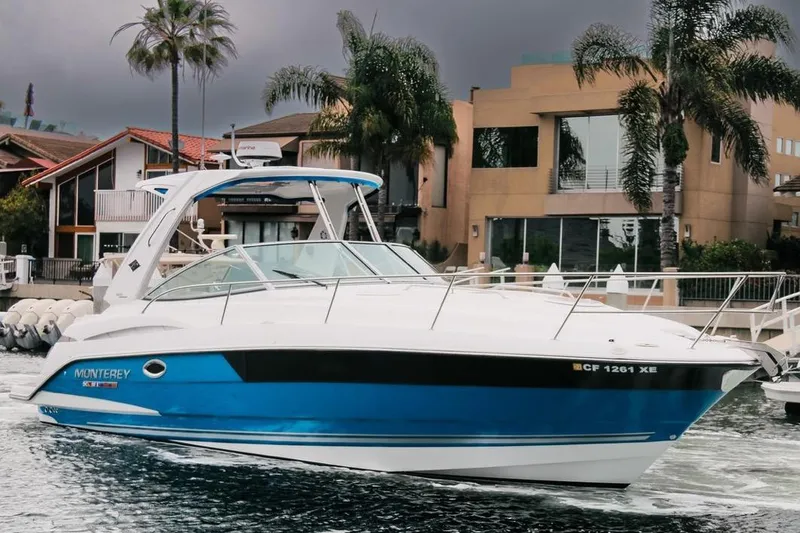 Slide: The Image of 2020 Monterey 355 Sport Yacht cruising near waterfront homes and palm trees. - 1