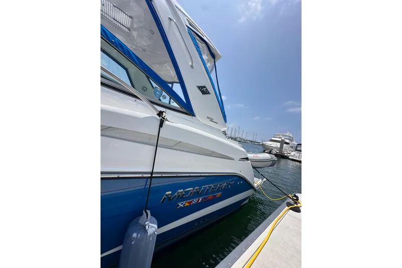 Slide: The Image of 2020 Monterey 355 Sport Yacht docked at marina under clear blue sky. - 12