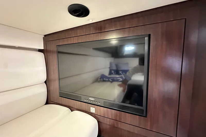 Slide: The Image of Interior of 2020 Monterey 355 Sport Yacht with wall-mounted TV and plush seating. - 53