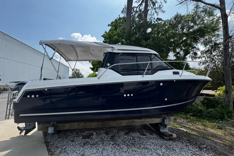 The Image of 2019 Jeanneau NC 795 boat on display, featuring sleek design and canopy. - 0