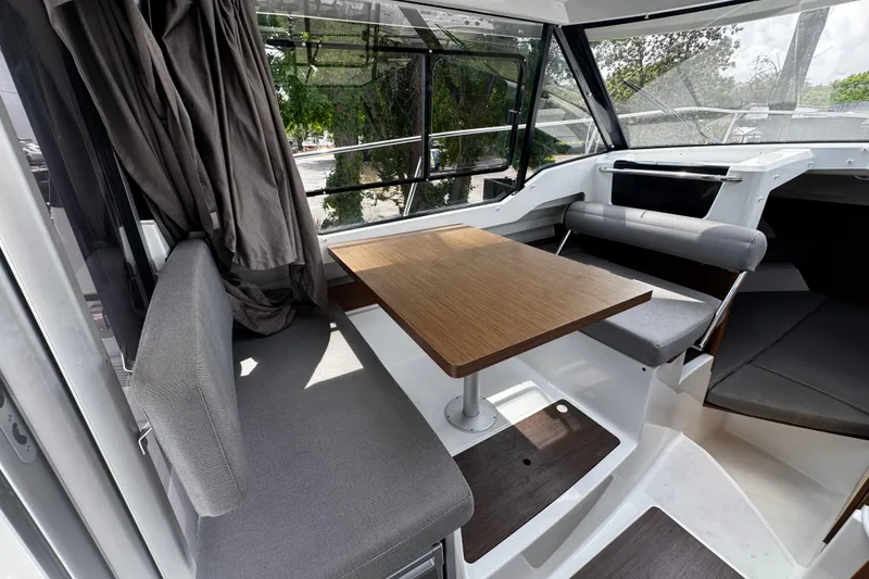 Slide: The Image of Interior of 2019 Jeanneau NC 795 boat with seating and wooden table. - 13