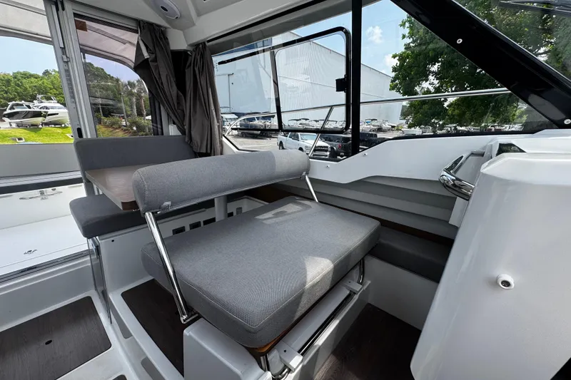 Slide: The Image of Interior of 2019 Jeanneau NC 795 boat with gray seating and modern design. - 14