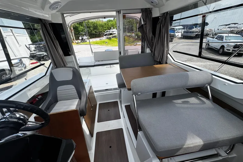 Slide: The Image of Interior of 2019 Jeanneau NC 795 boat with seating and steering wheel. - 15