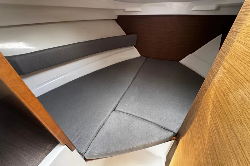 Slide: The Image of Cozy cabin interior of 2019 Jeanneau NC 795 with cushioned seating and wooden accents. - 16