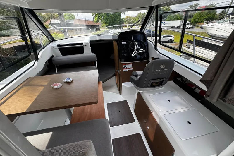 Slide: The Image of Interior of 2019 Jeanneau NC 795 boat with helm, seating, and table. - 5