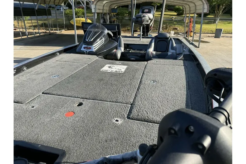 Slide: The Image of 2016 Ranger Z521 Comanche fishing boat with spacious deck and seating under covered dock. - 2