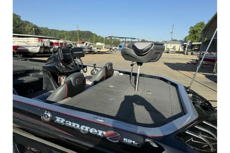 Slide: The Image of 2016 Ranger Z521 Comanche fishing boat with seating and control panel in a marina setting. - 20