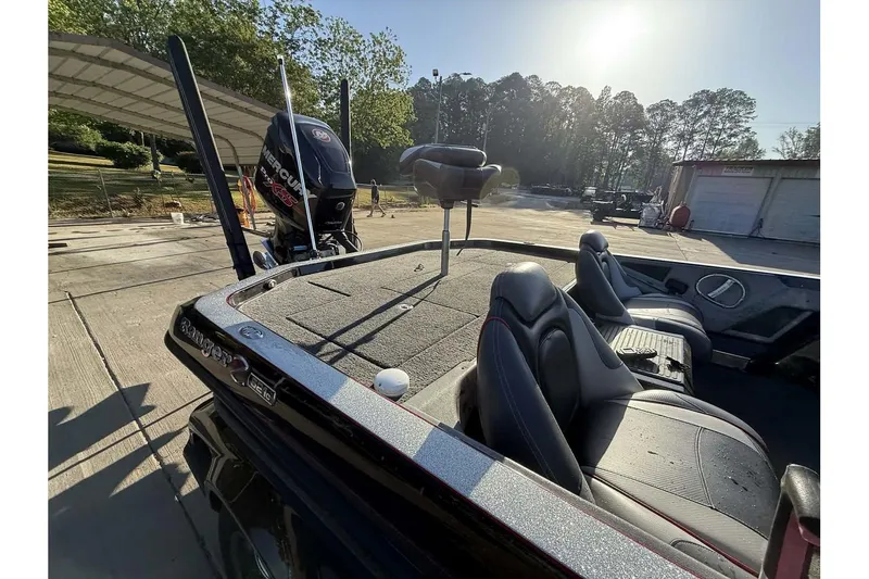 Slide: The Image of 2016 Ranger Z521 Comanche boat with seating and Mercury engine in a sunny outdoor setting. - 23