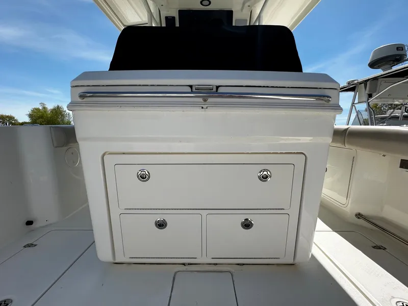 Slide: The Image of 2019 Boston Whaler 330 Outrage cockpit storage area. - 16