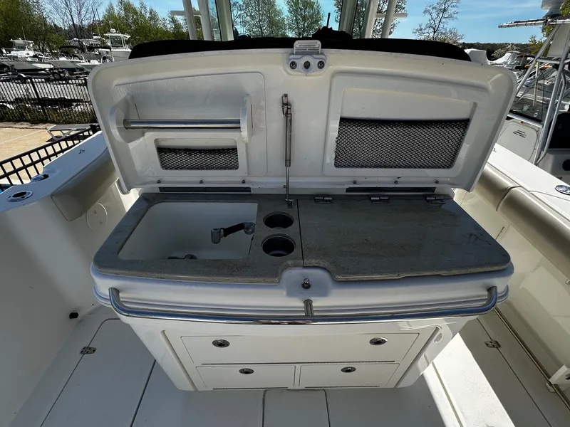 Slide: The Image of 2019 Boston Whaler 330 Outrage with integrated sink and storage. - 17