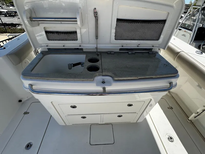 Slide: The Image of 2019 Boston Whaler 330 Outrage with integrated sink and storage area. - 18
