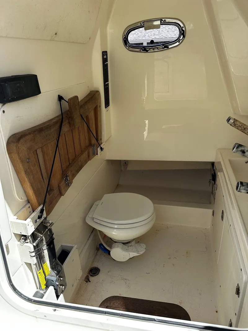 Slide: The Image of Interior of a 2019 Boston Whaler 330 Outrage with toilet. - 27