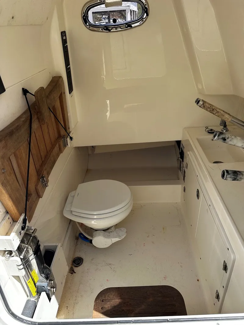 Slide: The Image of Interior of a 2019 Boston Whaler 330 Outrage with toilet. - 29