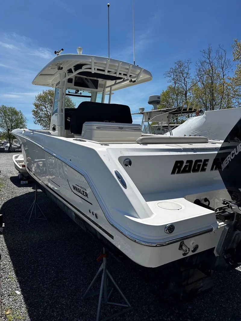 Slide: The Image of 2019 Boston Whaler 330 Outrage boat on a parking lot. - 3