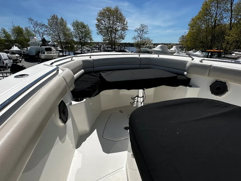Slide: The Image of 2019 Boston Whaler 330 Outrage boat with cushioned seating area. - 36
