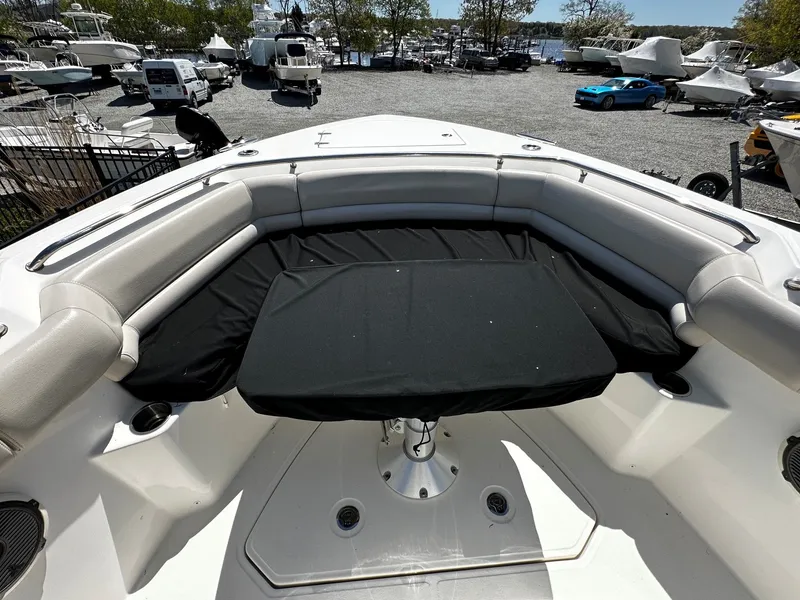 Slide: The Image of 2019 Boston Whaler 330 Outrage boat with cushioned seating area. - 37