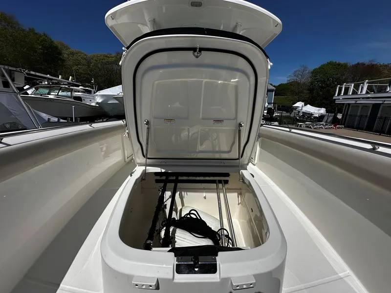 Slide: The Image of Boston Whaler 330 Outrage 2019 storage compartment with open lid. - 39