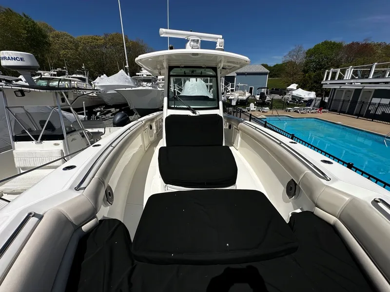 Slide: The Image of 2019 Boston Whaler 330 Outrage, luxury boat docked by pool. - 41