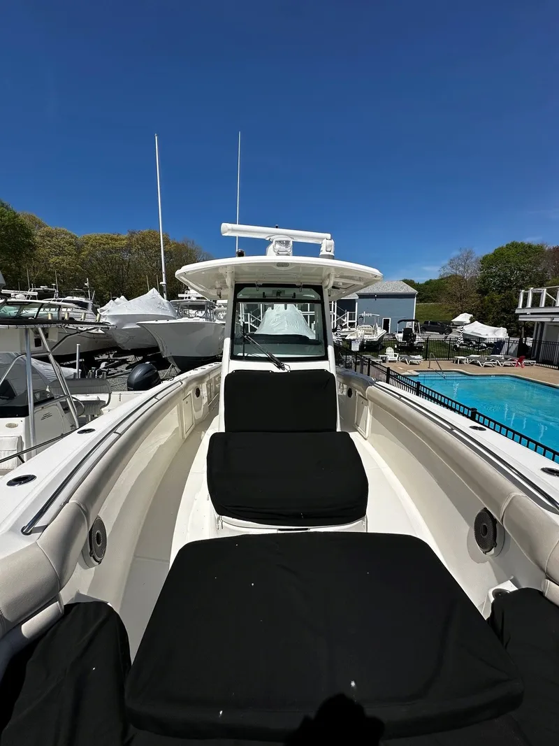 Slide: The Image of 2019 Boston Whaler 330 Outrage boat docked under clear blue sky. - 42